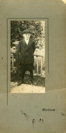 Grovenor 'Page' Newton II, born 20 June 1900, at about 10 years old, standing in front of a decor...