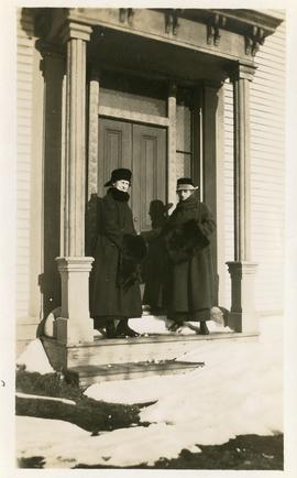 Grace Newton, on left, 21 March 1920, with a second lady, standing on the front step of a house (...